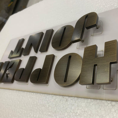 horizontal grain anodized bronze alum. letter